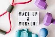 Flat lay of fitness equipment with a motivational slogan for exercise inspiration.